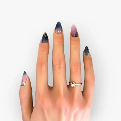 manucure sur une main de femme avec des ongles marbrés roses et bleus